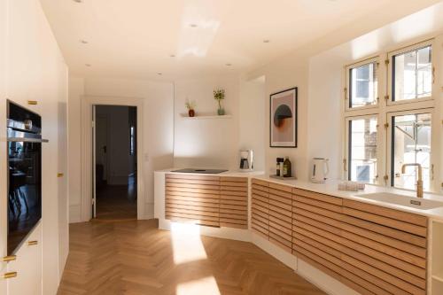 a kitchen with a counter and a sink at Lovely Apartment by w Bathtub and Balcony in Copenhagen