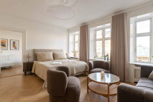 a bedroom with a bed and a couch and a table at Lovely Apartment by w Bathtub and Balcony in Copenhagen