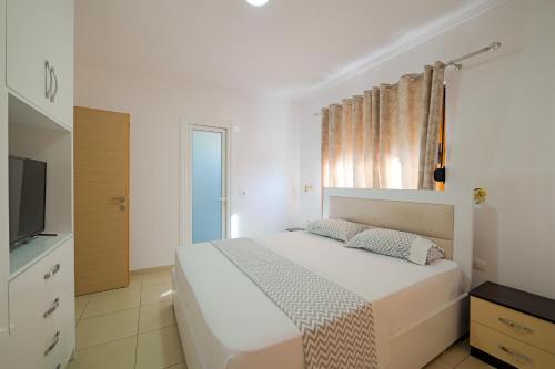 Ένα ή περισσότερα κρεβάτια σε δωμάτιο στο Vila Kristiano Ksamil