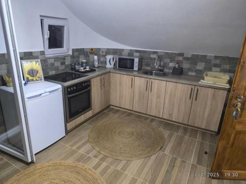 a small kitchen with a sink and a stove at Apartman Panonija Tuzla in Tuzla