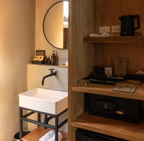 a small bathroom with a sink and a mirror at Escape Beach Resort - New Look & Improved in Mae Nam