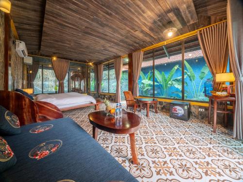 Pokój z łóżkiem, kanapą i stołem w obiekcie Trang An Mountain Resort w mieście Ninh Binh