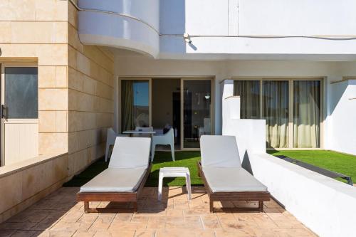 two chairs and a table on a patio at Piere - Anne Beach Hotel in Ayia Napa