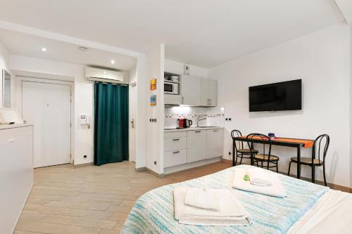 une chambre avec un lit et une cuisine avec une table dans l'établissement Les Oranges Five Stars HolidayHouse, à Nice