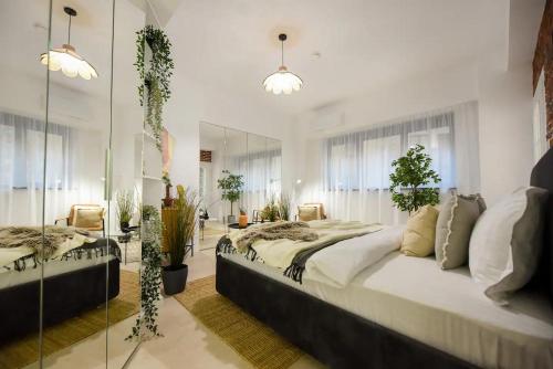 a bedroom with two beds and a mirror at AIASTAY Bucharest River Apartments in Bucharest