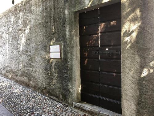 a door to a building with a sign on it at Casa Gialla by Fewotessin in Verscio