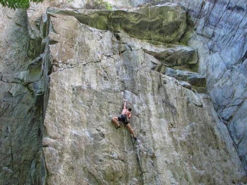 a man is climbing on a rock wall at Casa Gialla by Fewotessin in Verscio