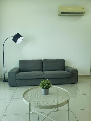 a living room with a couch and a table at Southbay Seaview Condo A23 #10minQueensbay in Bayan Lepas