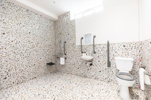 a bathroom with a toilet and a sink at The Chapter Hotels - Finsbury Park in London