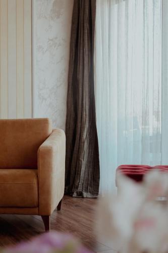 a living room with a chair and a window at Nafron Hotel in Prizren