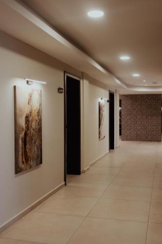 a hallway with paintings on the walls of a building at Nafron Hotel in Prizren