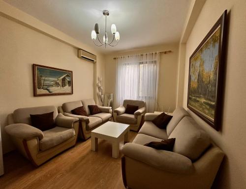 a living room with couches and a table at Guest house in Tirana