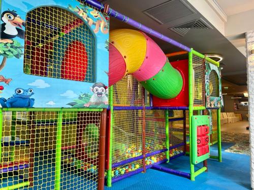 a play room with a slide and a playground at Hotel Pacific in Timişoara