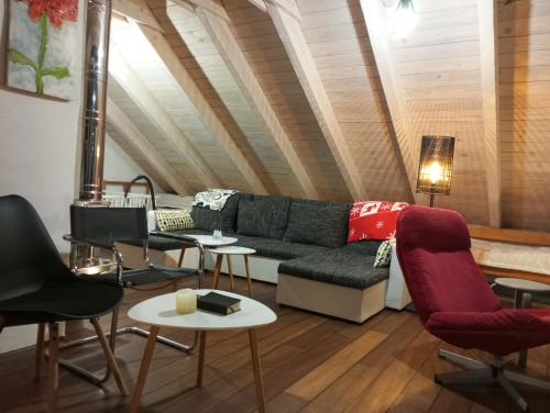 a living room with a couch and chairs at Nové podkrovie umelca in Trnava