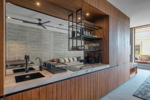 a kitchen with a sink and a counter at Body Factory Lifestyle Residence in Canggu