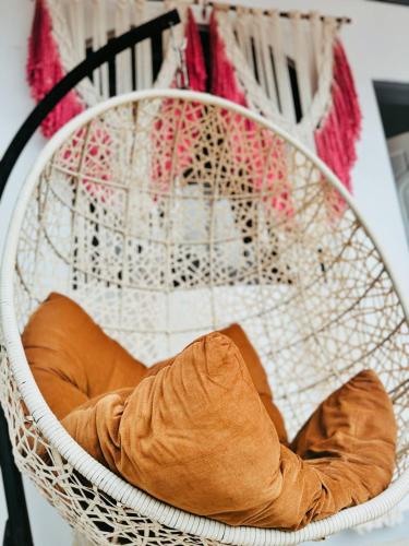 a white basket with a pillow in it at Dreamscape Villa in Batangas City