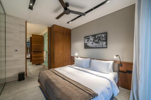 a bedroom with a large bed with white pillows at Body Factory Lifestyle Residence in Canggu