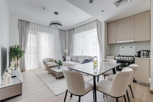 a kitchen and a living room with a table and chairs at Knokey Dubai Creek Beach with Lagoon Pool access in Dubai