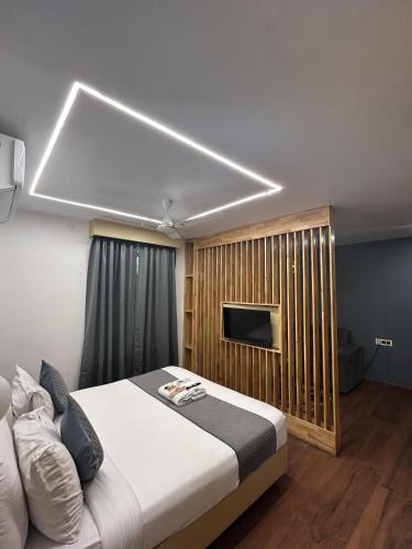 a bedroom with a bed and a television in it at Wild Wings Premium Hotel in Hyderabad
