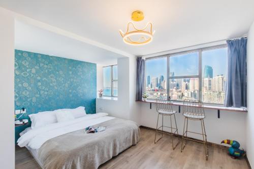 a bedroom with a bed and two stools in front of a window at Qingdao Shanhaiji Sea View B&B Wusi Square Branch in Fushansuo