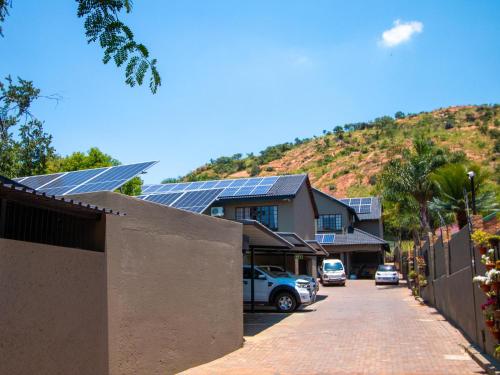 a house with solar panels on the side of a street at Casa Albergo Corporate Guest House in Pretoria
