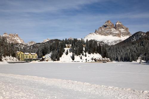 a frozen lake in front of a mountain at Grand Hotel Misurina in Misurina