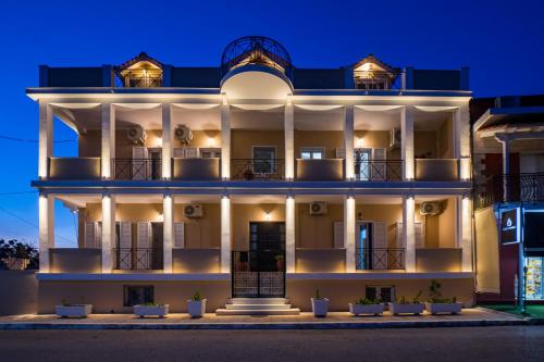 a large white building at night at Eraora Lofts & Apartments Kefalonia in Lakithra