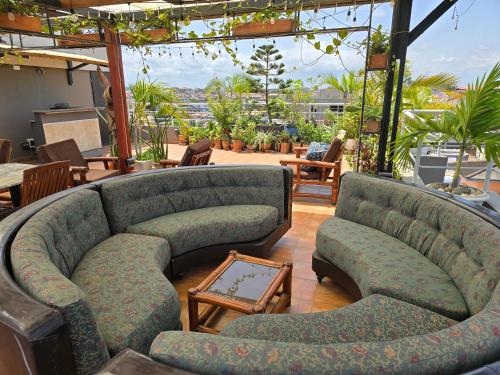 two couches and a coffee table on a patio at Acquah Place Residences in Accra