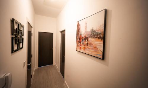 a hallway with a painting hanging on a wall at Amazing Apartment in Warrington in Warrington
