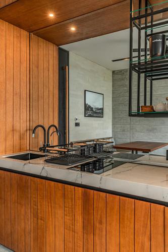 a kitchen with a sink and a counter top at Body Factory Lifestyle Residence in Canggu