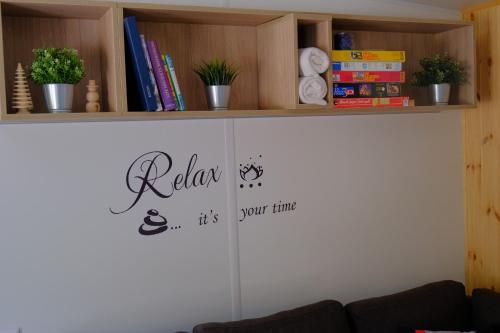 a room with a book shelf and a sign on the wall at Tinyhaus Sankt Rupert Nummer 11 in Riedenburg