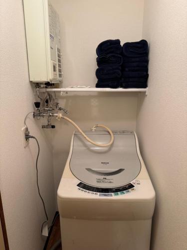 a sewing machine sitting on top of a toilet at STAY Moiwayama in Sapporo