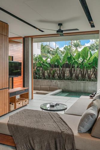 a living room with a couch and a table at Body Factory Lifestyle Residence in Canggu