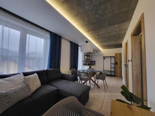 a living room with a couch and a table at USTROŃ RESIDENCE by VillaOlimpijska2 in Ustroń