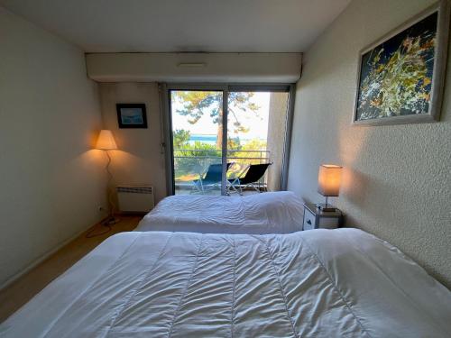 a bedroom with two beds and a window at C2111 Appartement Vue Mer Terrasse, Parking in Arcachon