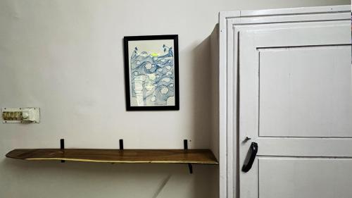 a wooden shelf on a wall next to a door at BLUE SOPHY Residency in Varkala