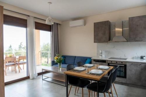 a kitchen and dining room with a table and chairs at Terra Blue Suites - Nefeli in Kalyves