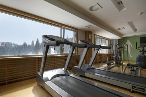 a gym with two treadmill machines and a large window at Apartman C437 Aparthotel Vucko Jahorina privatni apartman in Jahorina