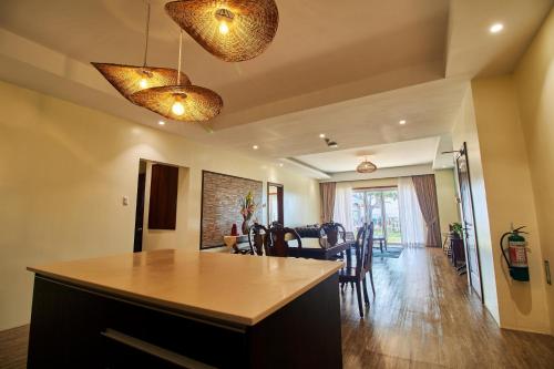 a kitchen and dining room with a table and chairs at Mactan Resort by 1521 in Mactan