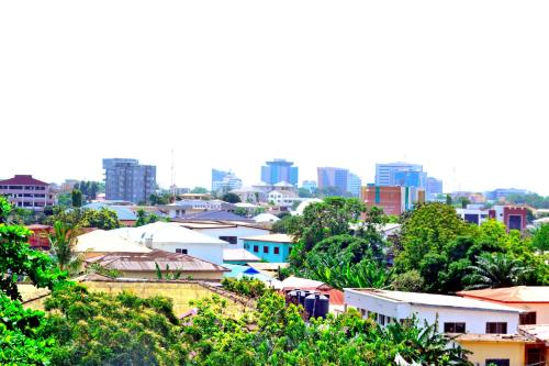 a view of a city with buildings and trees at Acquah Place Residences in Accra