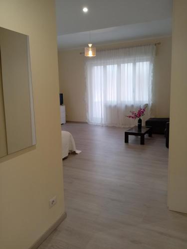 an empty living room with a couch and a window at Affittacamere Lusitana Alloggi 2 in Foligno
