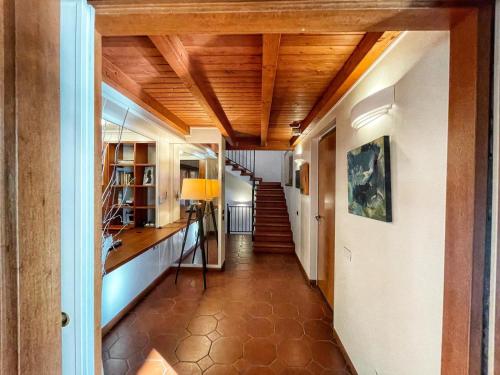 a hallway of a house with wooden ceilings at Guest House La Selvotta in Formello