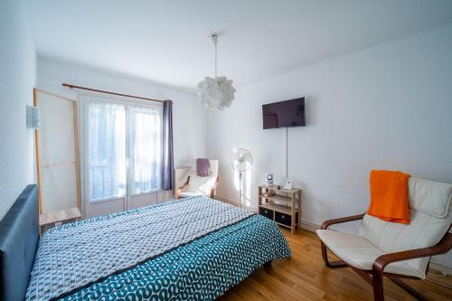 une chambre avec un lit, une chaise et une fenêtre dans l'établissement Le Vieux Pont - Vue montagne parking privé, à Amélie-les-Bains-Palalda