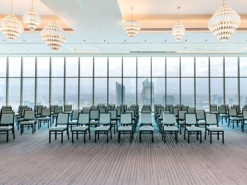 a large room with chairs and chandeliers at Sofitel Mexico City Reforma in Mexico City