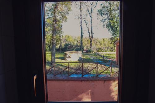 a view of a yard from a window at Guest House La Selvotta in Formello