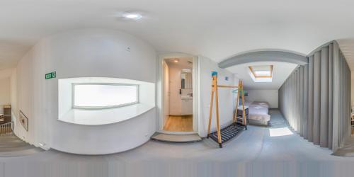 a white room with a hallway with a bed and a window at Villa Klara in Vodice