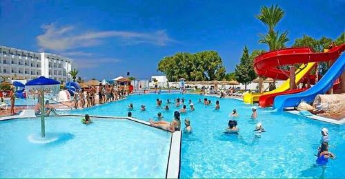 a group of people in a swimming pool at a water park at Aylimas Beach & Resort Monastir in Monastir