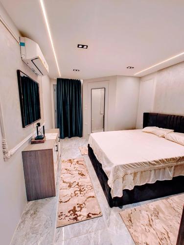 a bedroom with a bed and a table and a window at Luxury Furnished Condo in Egypt in Cairo