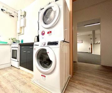 a washer and dryer in a room with a kitchen at Apart Residence KK in Glinde