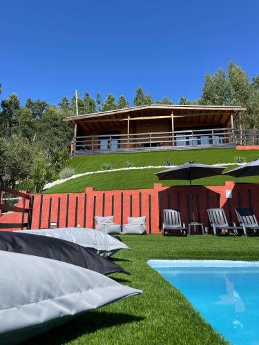 a group of pillows on the grass next to a building at Villa dos Pensamentos in Vila de Rei